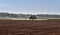 Tractor on plowed land.