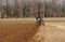 Tractor is plowing the agricultural field in preparation for spring sowing