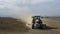 Tractor plowing a dusty field in delta