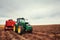 Tractor plowing farm field in preparation for spring planting