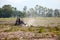 Tractor plowing field in sunny day