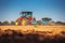 Tractor plowing the fields, agricultural landscape, panoramic view