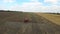 Tractor plowing the fields corn in spring. aerial