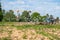 A tractor plows the field on a bright Sunny day. Rural spring landscape.