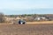 The tractor plows a field, cultivates the soil for sowing grain