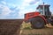 Tractor plows field, cultivators soil for sowing