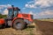 Tractor plows field, cultivators soil for sowing