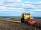 Tractor plows field. Tractor rides on the field and plows arable land.  Details and close-up.