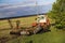 Tractor plows and harrows  land in  large field on  sunny spring day. preparing  soil for planting crops, plowing  soil with