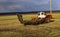 Tractor plows and harrows  land in  large field on  sunny spring day. preparing  soil for planting crops, plowing  soil with