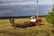 Tractor plows and harrows  land in  large field on  sunny spring day. preparing  soil for planting crops, plowing  soil with