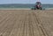 Tractor preparing land for sowing. Tractor with cultivator handles field before planting. Preparing land for sowing at spring