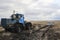 Tractor pulls a stuck car out of the fields