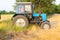 Tractor pulls up for loading to the combine with wheat