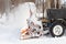 Tractor removes snow from city streets after snowfall