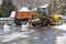 Tractor removing snow after snowfall. Winter season. Snow clearing.