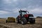 Tractor with Rock Picker in Spring