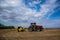 Tractor with Rock Picker in Spring