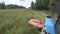 Tractor with rotary mower slowly rides on an inclined field at the end of turning