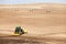 A tractor and scraper repairing erosion damage.