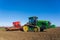 Tractor with seed drill sowing seeds in the Spring. Hertfordshire. UK