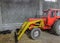 Tractor in a shed with haystacks