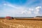 Tractor with a siding in a field during grain harvesting