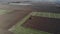 The tractor sows grain in the field.