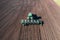 Tractor sows plowed soil on farm field, spring agriculture, aerial view from drone