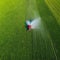 Tractor spray fertilizer on green field drone high angle agriculture background concept