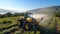 Tractor spraying chemical pesticides with sprayer on the large green agricultural field