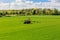 Tractor spraying glyphosate pesticides on a field