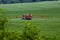 Tractor spraying pesticides on big green field