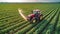 Tractor spraying pesticides on a vast green soybean plantation. AI Generated.