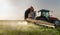 Tractor spraying wheat field