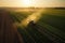 A tractor sprays chemicals to control pests and weeds in crops, ensuring healthier and more abundant harvests