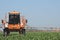 Tractor sprays Chemistry and Pesticides to a Farm\'s Field with vegetables