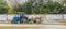 Tractor sprays grass with fertilizer on the farm, agriculture and rural agriculture