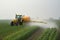 Tractor sprays pesticides on corn fields. Generative AI