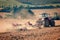 Tractor and stubble plough in an harvested field