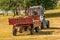 Tractor takes out cut grass in park