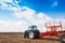 Tractor with tanks in the field. Sowing complex. Agricultural machinery and farming.