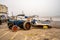 Tractor and traditional crab fishing boat parked up on Cromer beach