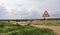 Tractor traffic sign in farm landcape