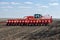 Tractor with trailed planter on the field