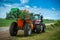 Tractor with trailed sprayer, near winter crop field, spring crop fertilizers, beautiful sky