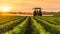 A tractor treats the field with herbicide. Selective focus.