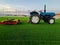 A tractor treats football field grass