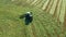 A tractor turns up the grass, aerial view.