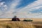 Tractor Under Blue Sky on Canadian Prairie